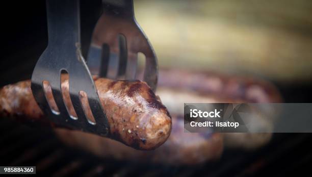Taking Sausage Off The Grill Stock Photo - Download Image Now - Barbecue - Meal, Barbecue Grill, Burnt