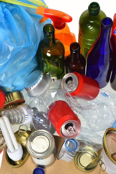istock trash for recycling with, glass bottles, cans, plastic bottle and bulb 985884364
