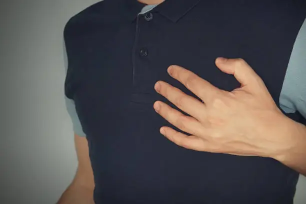 man touching with his hands with aheart attack chest pain with angina pectoris, mental pain, mental suffering. experience, feeling, emotion, worry,