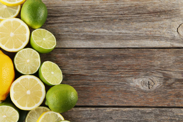 istock Ripe limes and lemons on wooden table 985898920