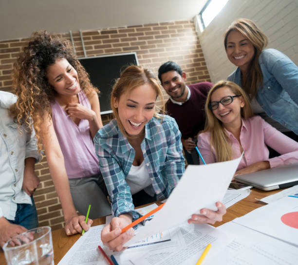 istock Happy business group working together at a creative office 985899286