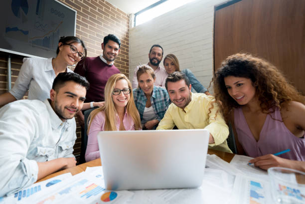istock Happy group of people working online at a creative office 985899324