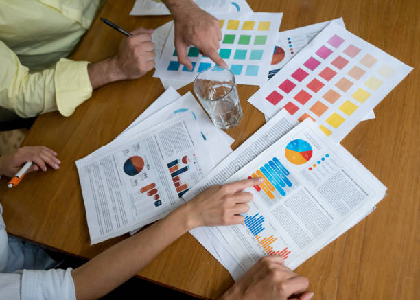istock Business people in a meeting at the office looking at documents 985899542