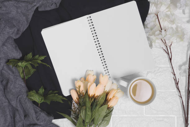 istock Open spiral notebook with blank pages on wood background. 985903340