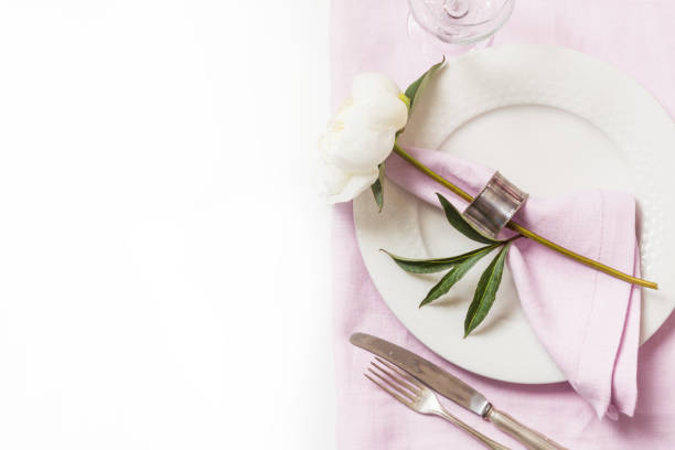 istock Romantic dinner. Elegance table setting with plant on pink linen tablecloth. Top view. 985903864