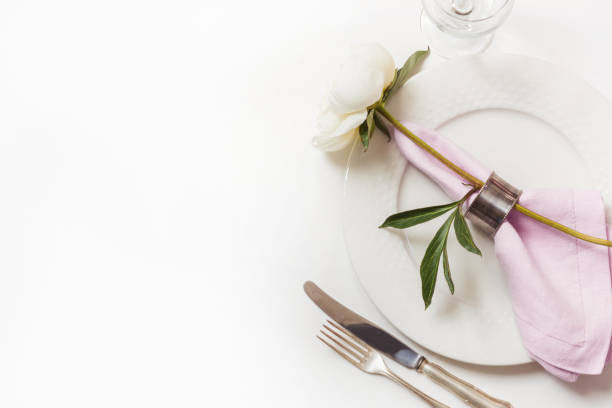 istock Romantic dinner. Elegance table setting with plant on pink linen tablecloth. Top view. 985903868