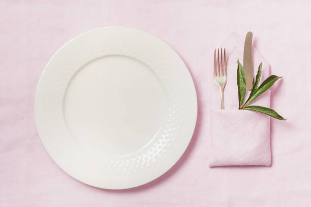 istock Romantic dinner. Elegance table setting with plant on pink linen tablecloth. Top view. 985903888