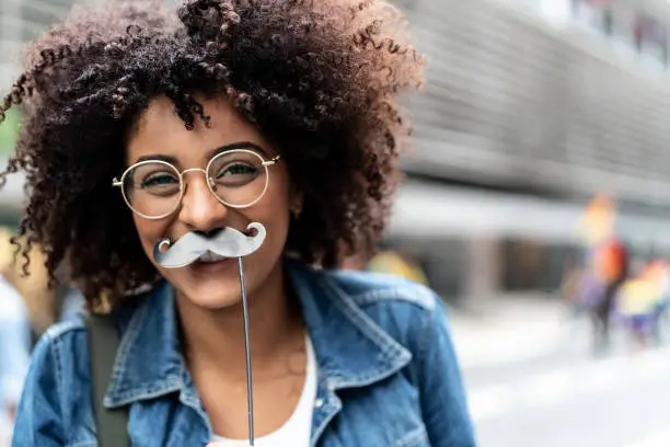 Photo of Portrait of a Young Girl Having Fun with Mustache