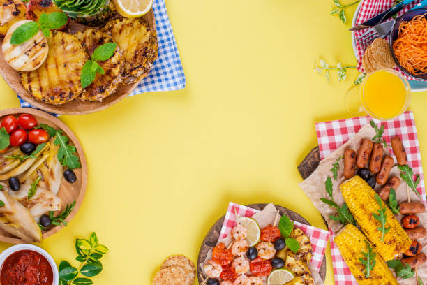 istock Different fruits and vegetables on grilled and shrimp. Yellow background. Summer dinner. Copy space. flat lay 985908832