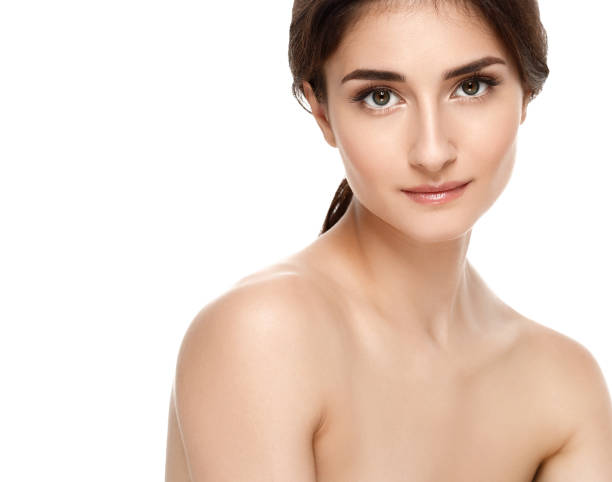 istock Beautiful woman face close up studio on white. 985908864