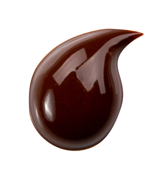 istock Melting chocolate drips. Chocolate isolated on white background. 985909506