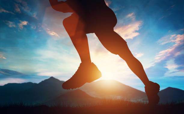 istock Man running in the mountains at the sunset. 985909768