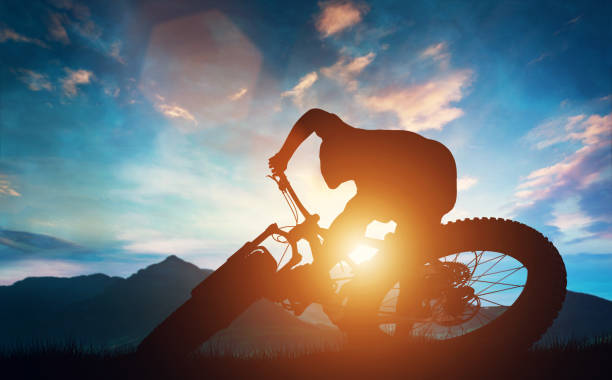 two friends biking to the summits of the mountains and celebrating the victory