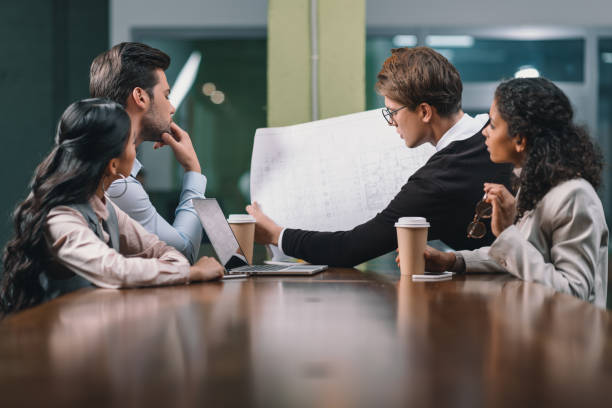 istock multiethnic business team working with blueprint on meeting 985914336