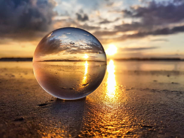istock Watching sunrise throught a lens ball - Riviera Romagnola 985916104