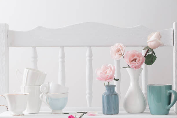 istock pink roses on vintage wooden white shelf 985918928