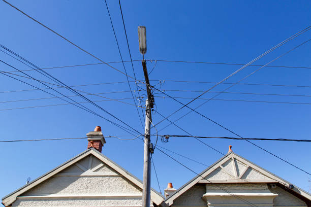 Roof view of two detached bungalows in Melbourne - Australia. Close up of the roof apex and telegraph pole outside two detached bungalow homes in the residential suburb of St Kilda in Melbourne. utility pole with power lines close up stock pictures, royalty-free photos & images