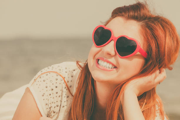 istock Redhead adult woman lying on beach 985924862