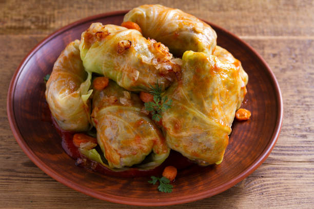 istock Cabbage rolls with meat, rice and vegetables. Stuffed cabbage leaves with meat. Chou farci, dolma, sarma, golubtsy or golabki 985925722