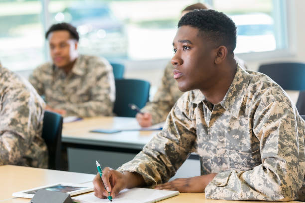 istock Young cadet takes notes at military academy 985941198