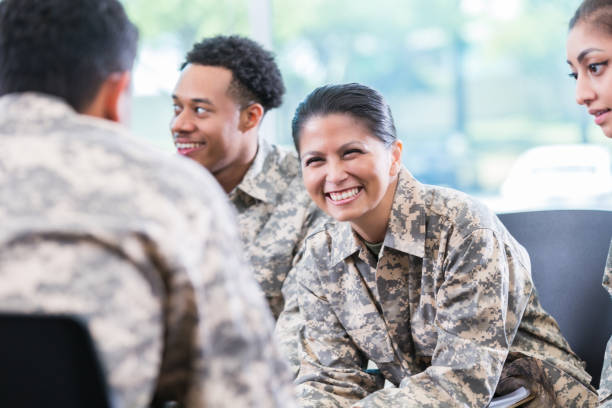 istock Cheerful female soldier participates in discussion group 985941236