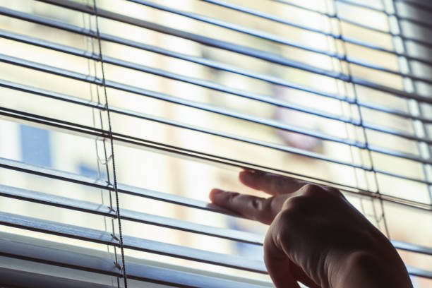 istock Texture of venetian blind with hand 985946194