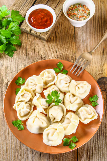 istock Homemade ready dumplings on an old wooden table. 985946586