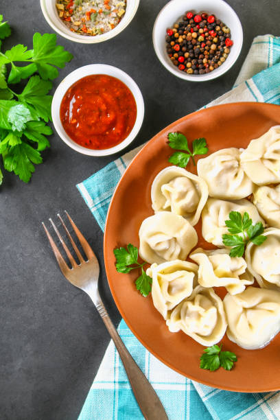 istock Homemade ready dumplings on a gray concrete table. 985946602