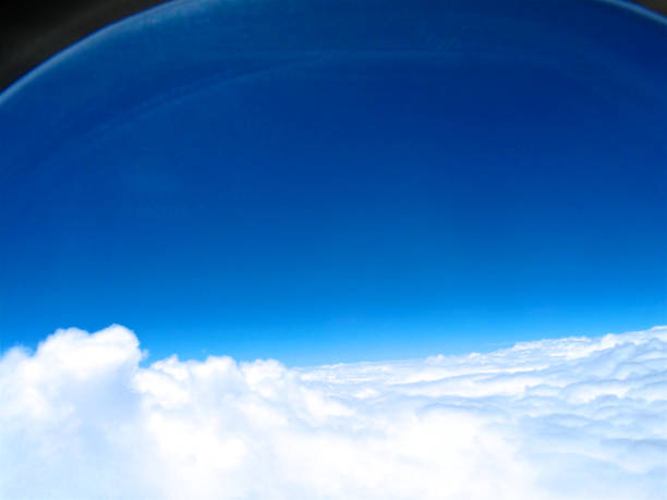 istock Sky and clouds as seen through the window of an airplane. 985952926