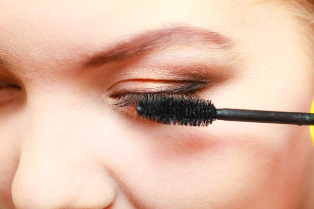 istock Close up woman getting make up, mascara 985959606