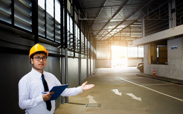 istock Male engineer checking in factory With note on notepad or industry blurred background.Metaphor Quality inspection or Production speed For the best quality to customers. 985963426