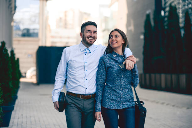 istock Business Couple Enjoying Beautiful Weather After Work 985971486
