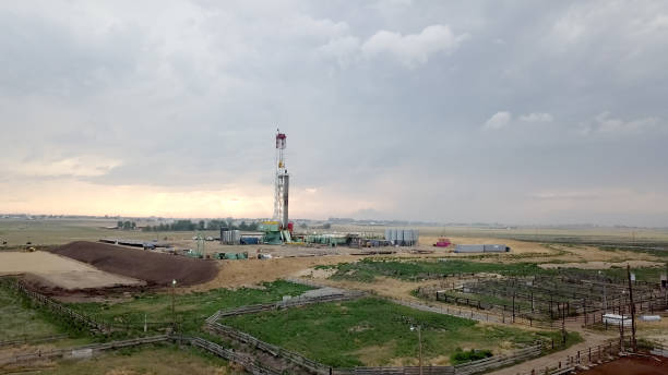 istock Fracking Drilling Rig in Front of a Dramatic Sky at Dusk 985972728