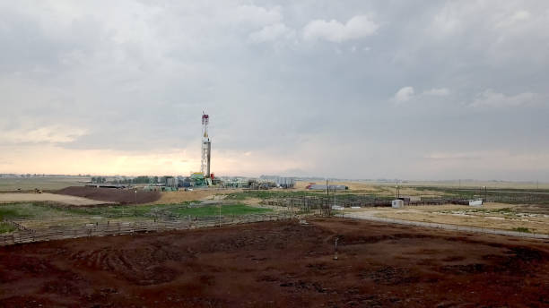 istock Fracking Drilling Rig in Front of a Dramatic Sky at Dusk 985973632