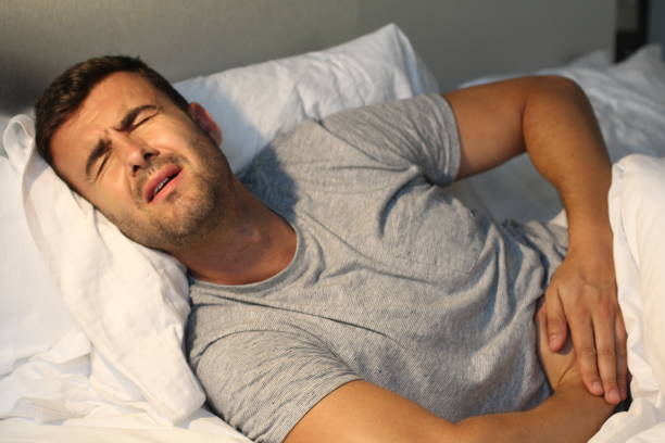 istock Man with stomach pain suffering 985975882