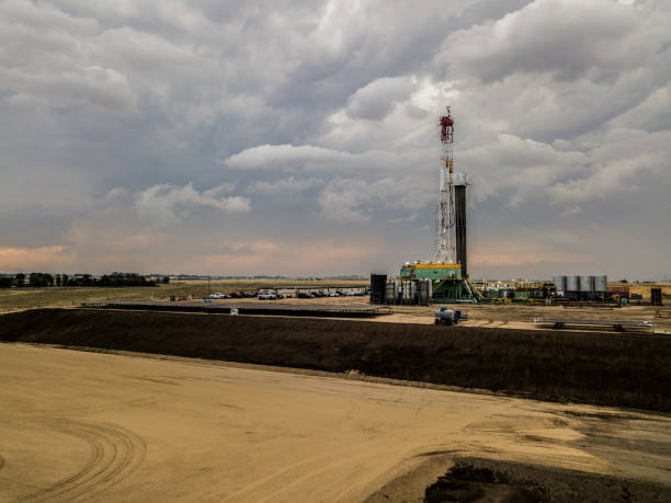 istock Fracking Drilling Rig in Front of a Dramatic Sky at Dusk 985978110