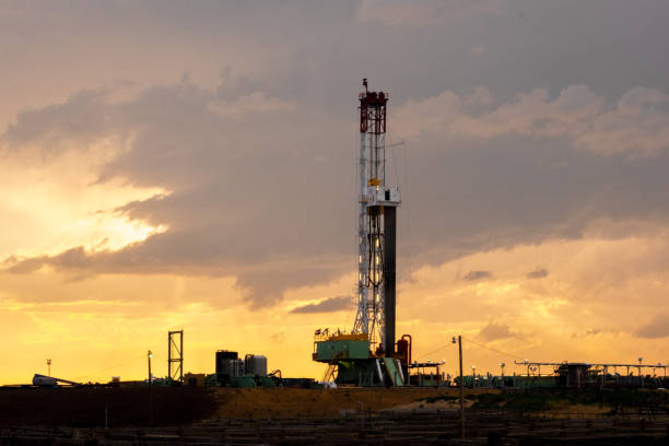 istock Fracking Drilling Rig in Front of a Dramatic Sky at Dusk 985980542