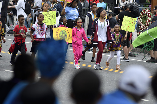 Philadelphia, PA, USA - June 23, 2018; A group of children promoting the Philadelphia based Lest We forget Slavery Museum participates in the annual Juneteenth parade in Center City Philadelphia, PA, on June 23, 2018. The Juneteenth Independence Day or Freedom Day commemorates the announcement of abolition of slavery on June 19, 1865.