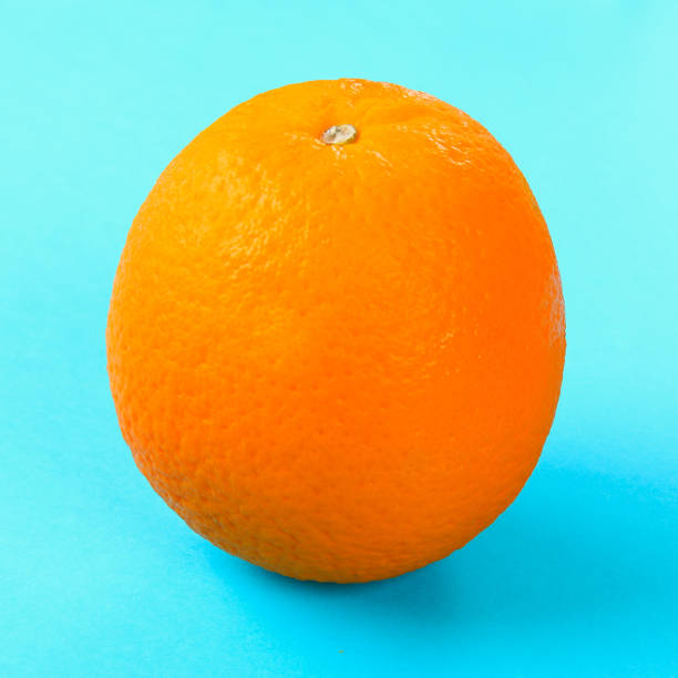 istock Orange whole orange on pastel blue background. 985984164