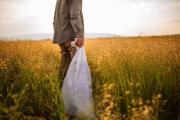 istock Farmer with a sack on his field 985995132