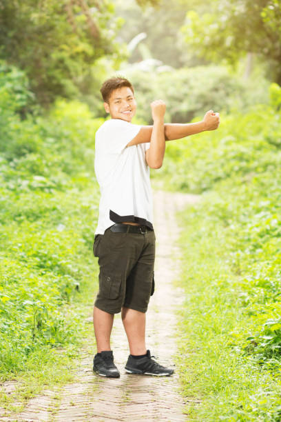 istock Asian male doing stretching outdoor 985995626