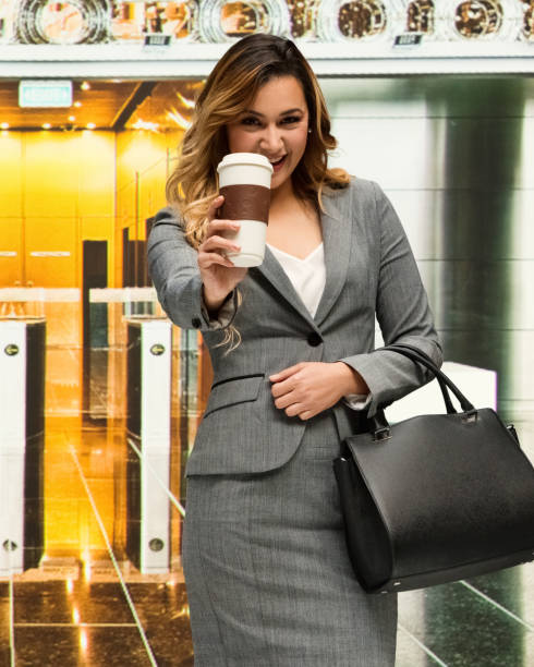 istock Business woman is happy while holding coffee cup 985999840