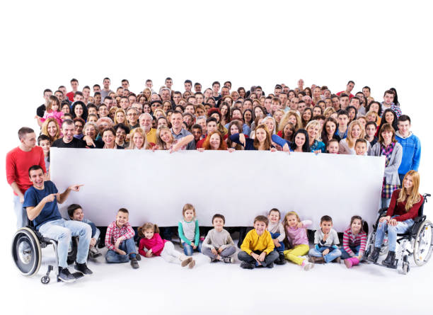istock Large group of happy people holding big white banner. 986010344