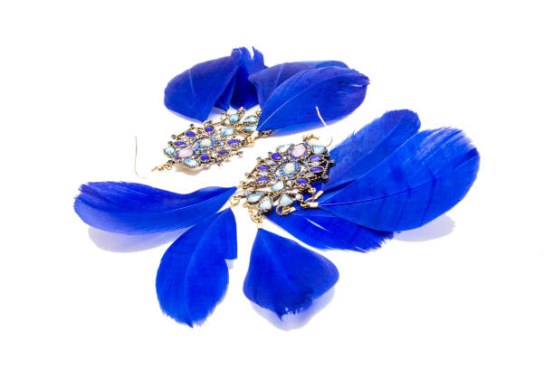 istock Earrings with blue feathers isolated on white 986020312