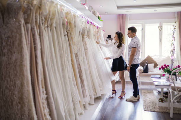 istock Lovely couple picking up a wedding dress 986020582