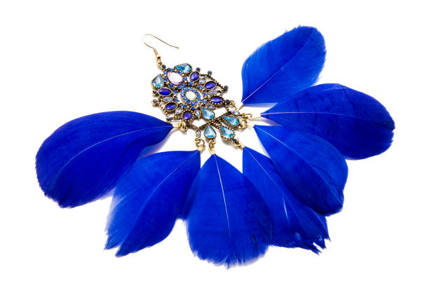 istock Earrings with blue feathers isolated on white 986021074