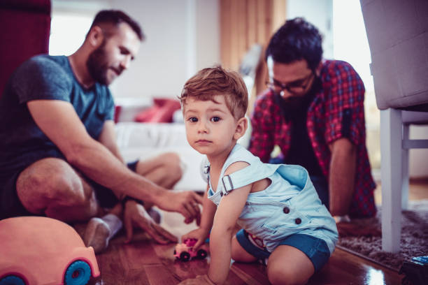 istock Gay Couple Playing And Bonding With Adopted Son 986024122