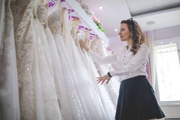 istock Lovely woman looking at wedding dresses 986031536