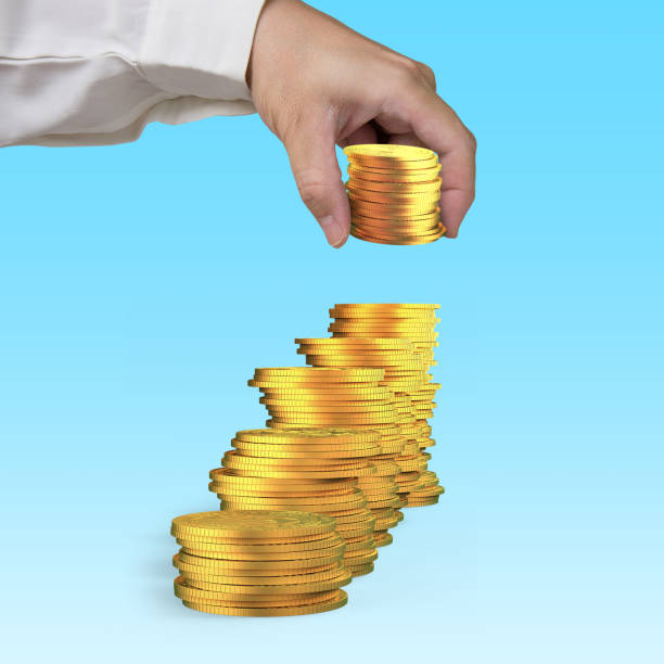 istock Hand arranging golden coins to stack as step stairs 986031604