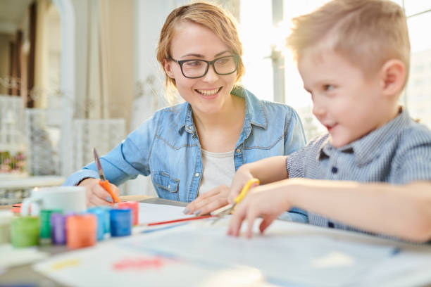 istock Happy Mother and Son Crafting Together 986044712